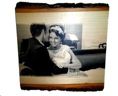 a black and white photo of a couple on their wedding day, taken in an old frame