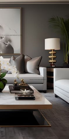 an elegant living room with white furniture and flowers on the coffee table