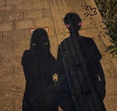 the shadow of two people standing next to each other