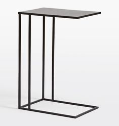 a black metal table with a square top and two bars on the bottom, in front of a white background