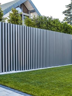 a white fence in front of a house