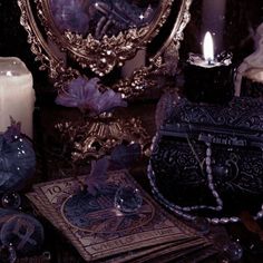 a mirror, candles and other items on a table