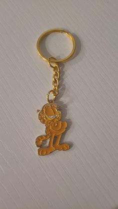 a gold keychain with a monkey on it