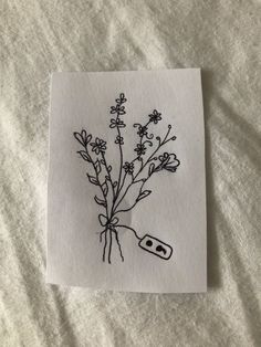 a piece of paper with a drawing of flowers on it and an object in the middle