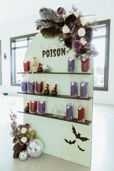 there is a display with candles and decorations on the shelves in front of it that says poison