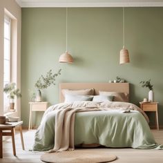 a bedroom with green walls and white bedding in the center, along with two lamps hanging from the ceiling