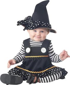 a baby wearing a black and white striped dress