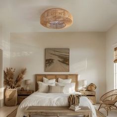 a bedroom with white bedding and wicker furniture