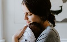 a woman holding a baby in her arms