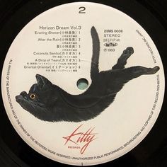 a black cat on a white and black label with the words kitty written below it