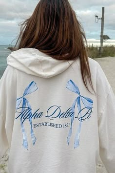 Product Color Vanilla Ice Product Description Elevate your sorority wardrobe with our Vanilla Ice Alpha Delta Pi Bow Matching Set Light Weight Hoodie. Crafted from the softest French terry fabric, this hoodie provides ultimate comfort and style, making it a staple year round. Embrace the perfect blend of warmth and breathability with this must-have addition to your collection Note: This product is designed for a comfortable and breathable fit. It is intentionally crafted as a lightweight option, Sorority Hoodie Design, Cute Sorority Merch, Sorority Instagram Stories, Alpha Phi Shirts, Sorority Hoodies, Coquette Design, Sorority Events