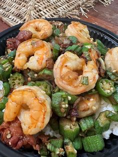 a bowl filled with shrimp and vegetables on top of rice