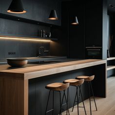 three stools sit in front of the kitchen counter