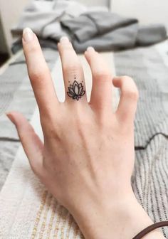 a woman's hand with a small tattoo on it