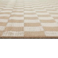 a beige and white rug with squares on it