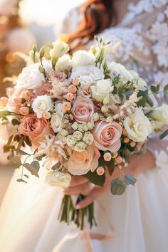 a bridal holding a bouquet of pink and white flowers