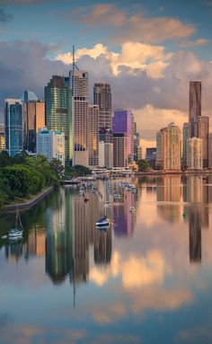 the city skyline is reflected in the water