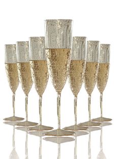 six champagne glasses are lined up in a row