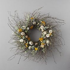 a dried wreath with yellow and white flowers