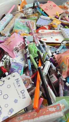 a box filled with lots of different types of pens and pencils on top of each other