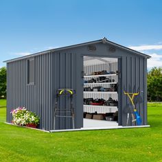 a metal shed with the door open and gardening tools in it's storage compartment