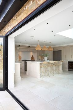 an open kitchen and dining area with large sliding glass doors