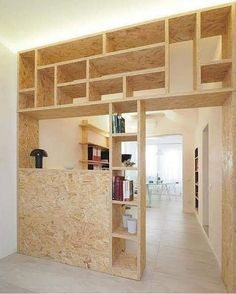 an empty room with bookshelves and shelves on the wall in front of it