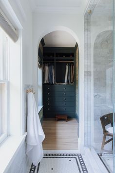 a walk in closet next to a window