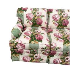 a floral couch with green and white striped upholstered fabric on the back, has pink flowers all over it