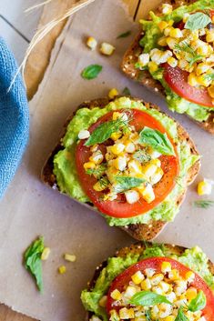 three pieces of bread with avocado and tomatoes on them