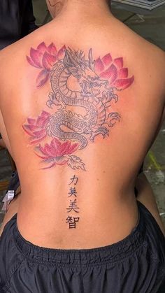 a woman with a dragon tattoo on her back