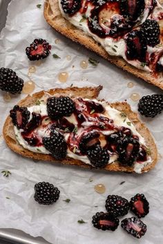 two pieces of bread with berries and cream on them