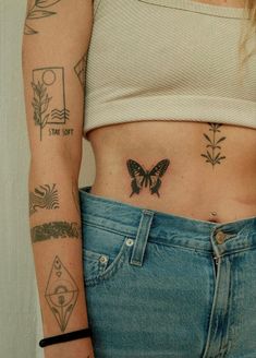 a woman's stomach with tattoos on it