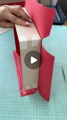 someone is making a box out of paper