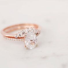 a rose gold engagement ring with an oval cut diamond in the center