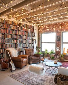 a living room filled with lots of furniture and bookshelves next to a window