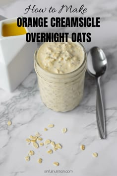 an orange creamsice overnight oats in a jar with spoons on the side