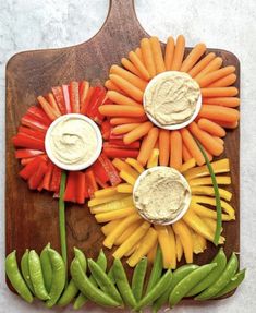 carrots, celery, and other vegetables are arranged on a cutting board