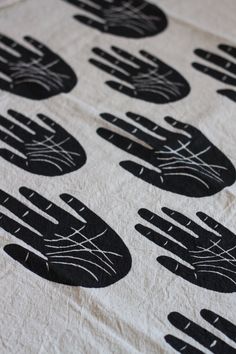 black and white fabric with hand prints on it