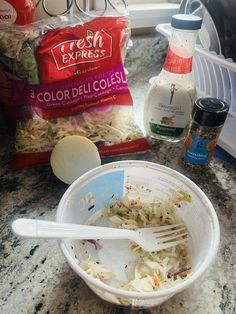 a bowl filled with coleslaw next to some ingredients