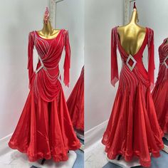 the back of a red evening gown with long sleeves and beading on display in front of a mirror