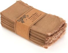 a stack of folded brown paper towels on top of each other with a label that says,