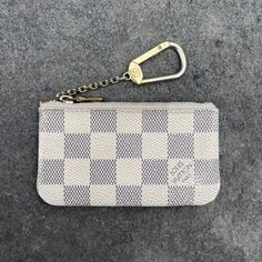 This Louis Vuitton Key Pouch Is A Stylish Accessory For Any Woman. The Damier Azur Color Gives It A Trendy Look, While The Canvas Material And Zipper Closure Ensure Durability. The Pouch Is Perfect For Carrying Your Credit Cards, Keys, And Coins, Making It A Versatile Addition To Your Collection. The Compact Size And Key Chain Feature Make It Easy To Attach To Your Bag Or Key Ring For Easy Access. Add A Touch Of Luxury To Your Daily Routine With This Louis Vuitton Key Pouch. Things To Note: * Discontinued Style * Overall Feeling Of Use * Tarnishing To Hardware * Interior Has Coin Residue * Dirt Along Zipper * 100% Authentic * No Accessories Luxury Wallet With Interior Key Chain Holder, Louis Vuitton Key Pouch, Key Pouch, Louis Vuitton Accessories, Coin Pouch, Key Card Holder, The Pouch, Stylish Accessories, Daily Routine