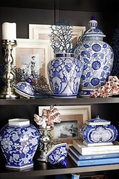 a shelf filled with blue and white vases