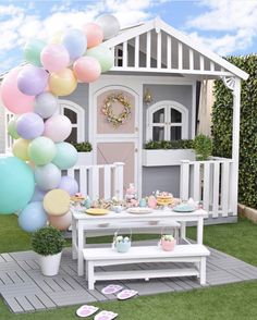 an instagram with balloons and cake on the ground in front of a small house