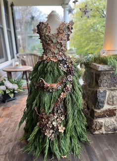 a dress made out of branches and leaves