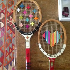 two tennis racquets are decorated with crosses