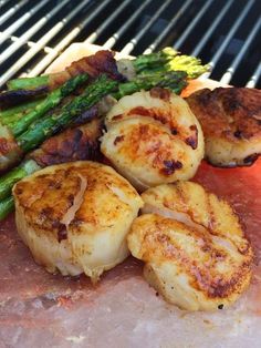 some scallops and asparagus on a grill