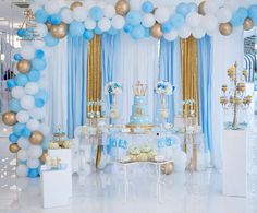 a blue and white dessert table with balloons