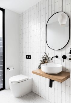 a bathroom with a sink, toilet and mirror